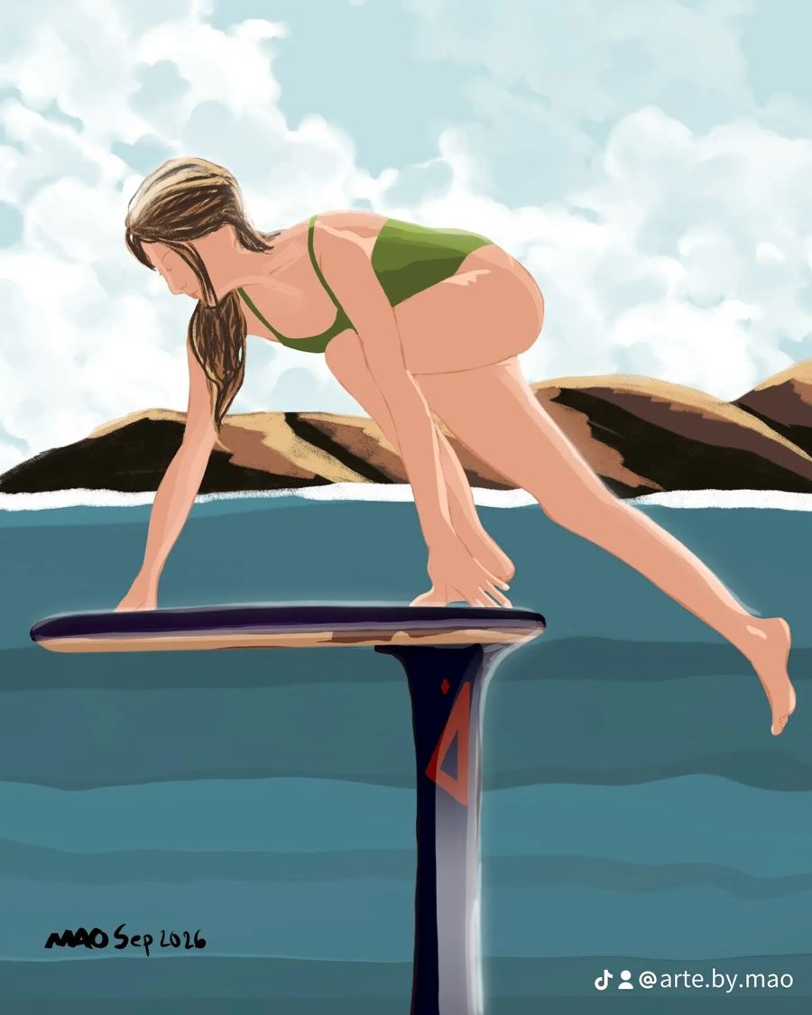 Woman in a green swimsuit climbing onto a hydrofoil board